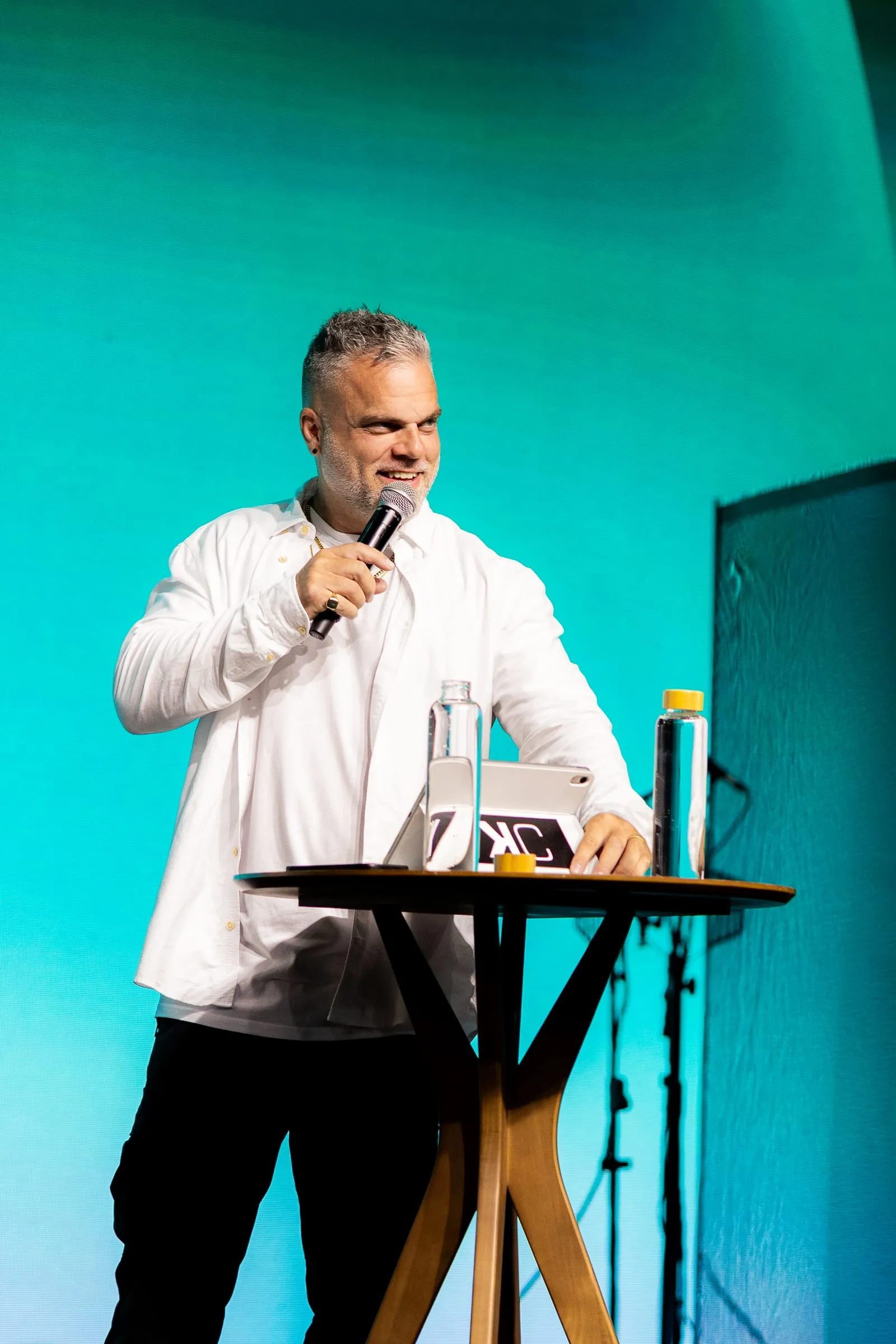 Shawn Gabie teaching on a stage beside a small table
