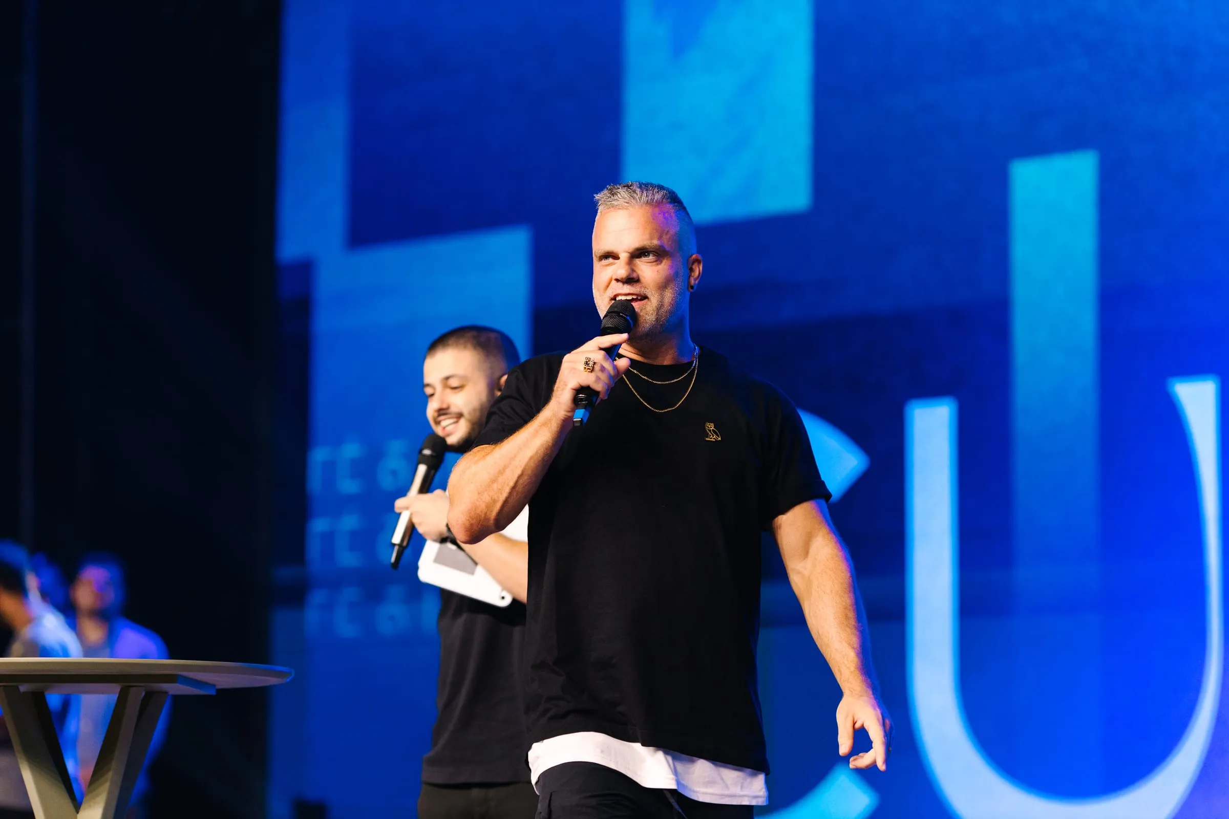 Shawn Gabie speaking on stage with notes in hand