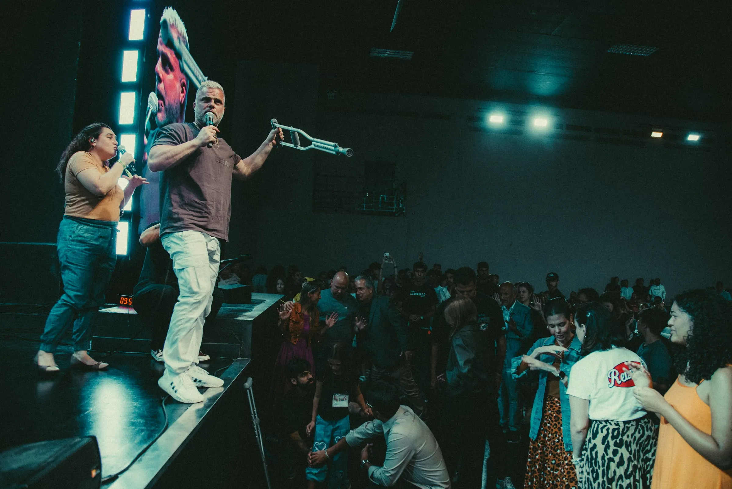 Shawn Gabie ministering from a stage to a large crowd