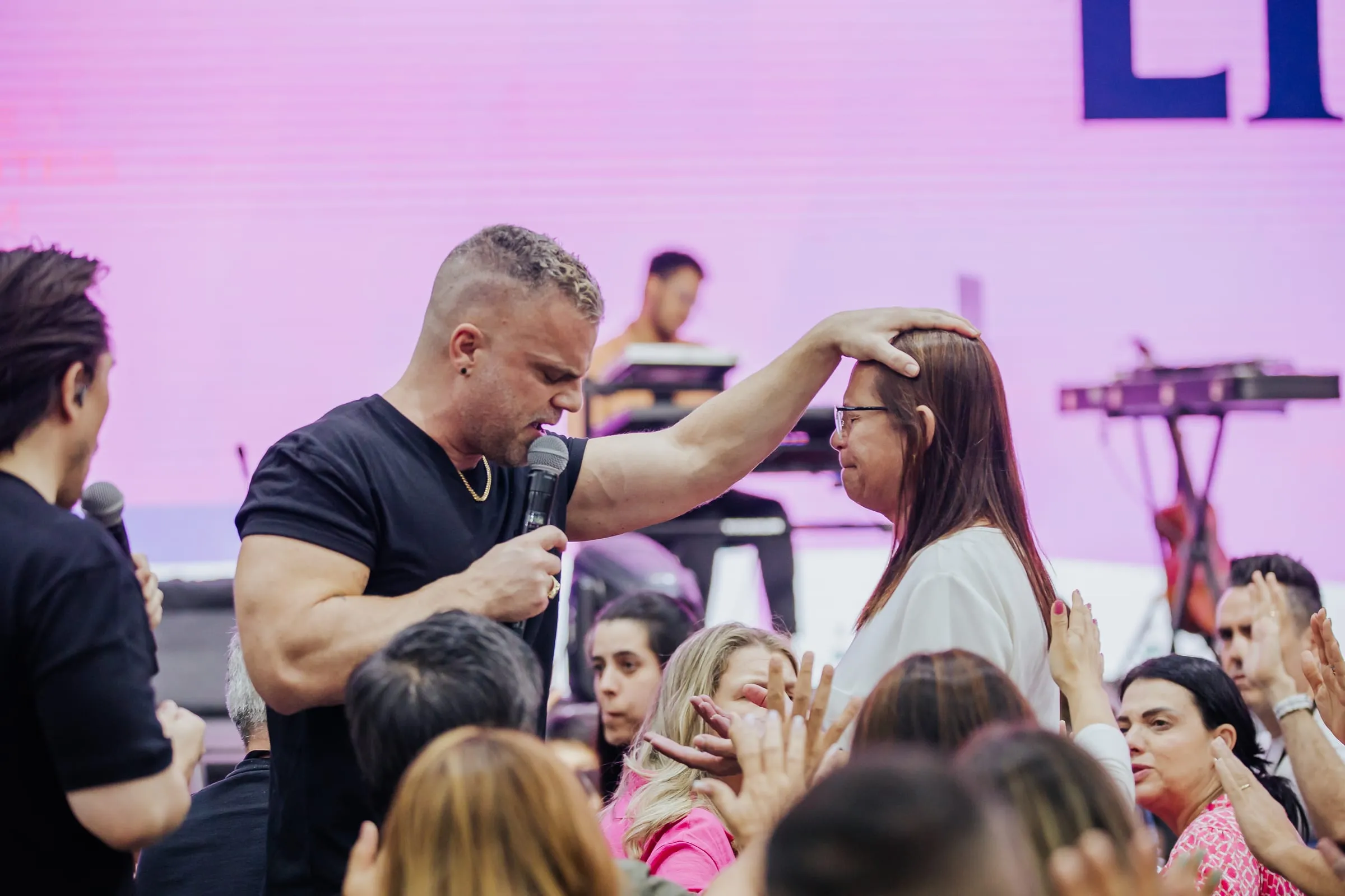 Shawn Gabie praying for a woman during a ministry moment